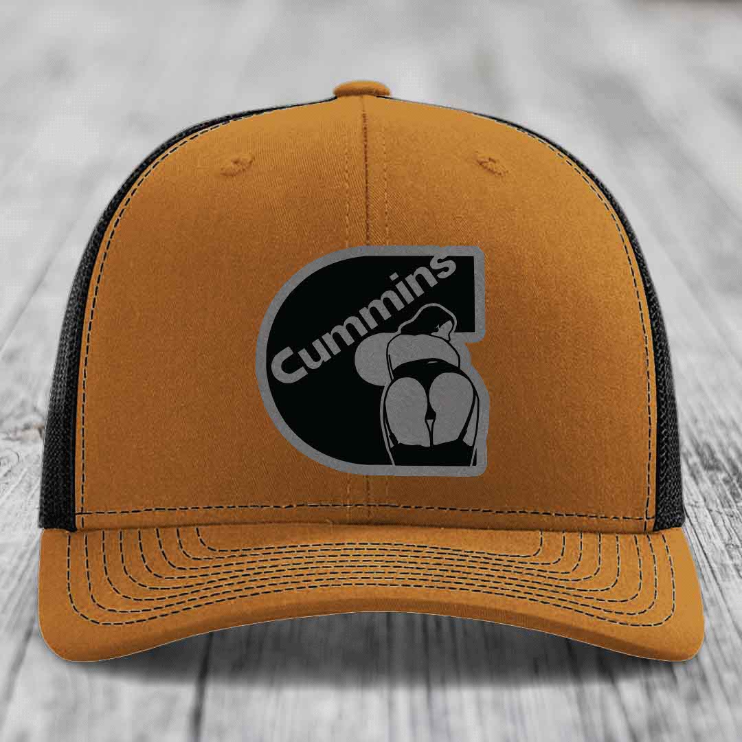 Grey trucker hat with black mesh back and Cummins logo patch on front.