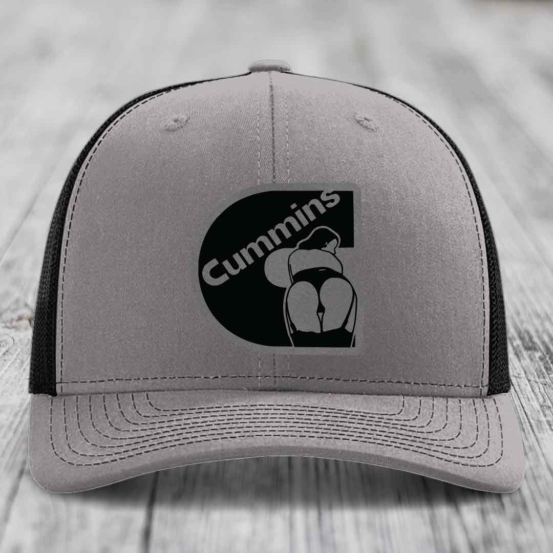 Grey trucker hat with blue mesh sides and a black Cummins logo patch on front.