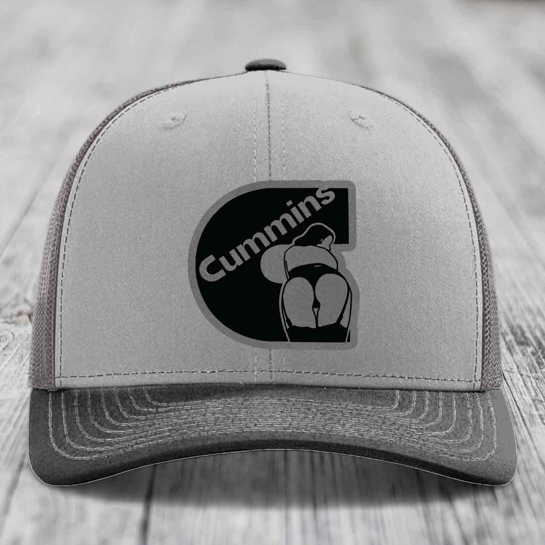 Grey and beige trucker hat with black Cummins logo patch on front.