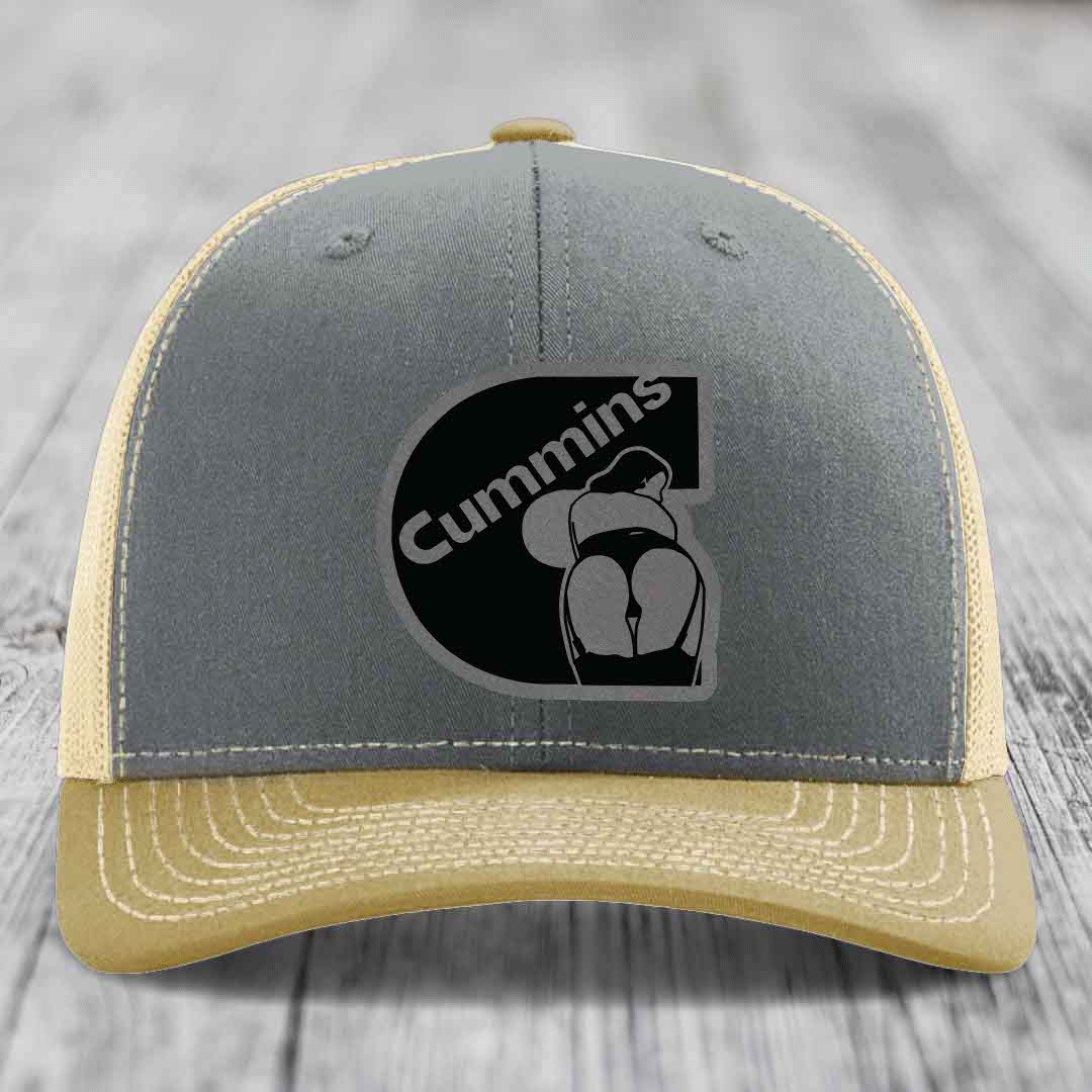 Grey trucker hat with black Cummins logo patch featuring a stylized figure.