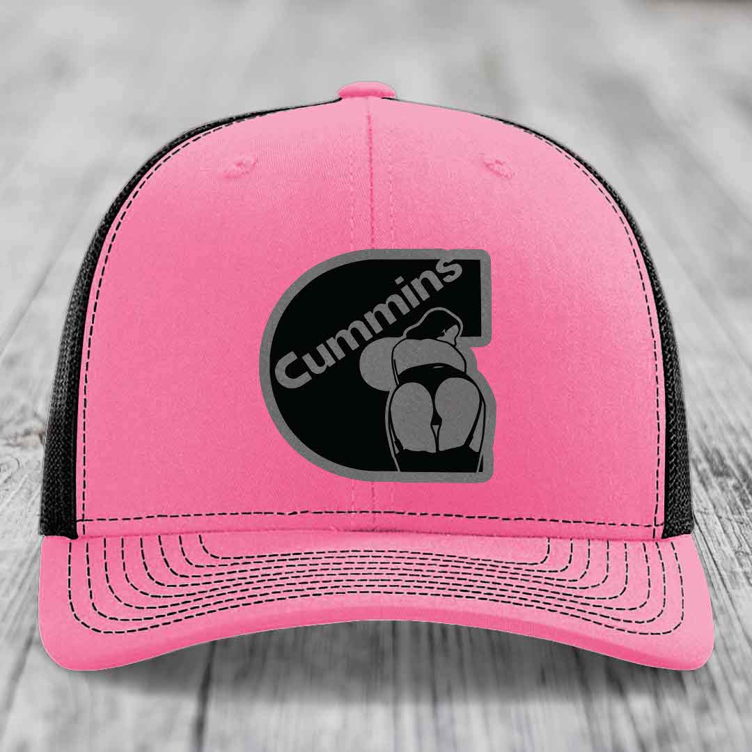 Green trucker hat with white mesh back and embroidered Cummins logo patch.
