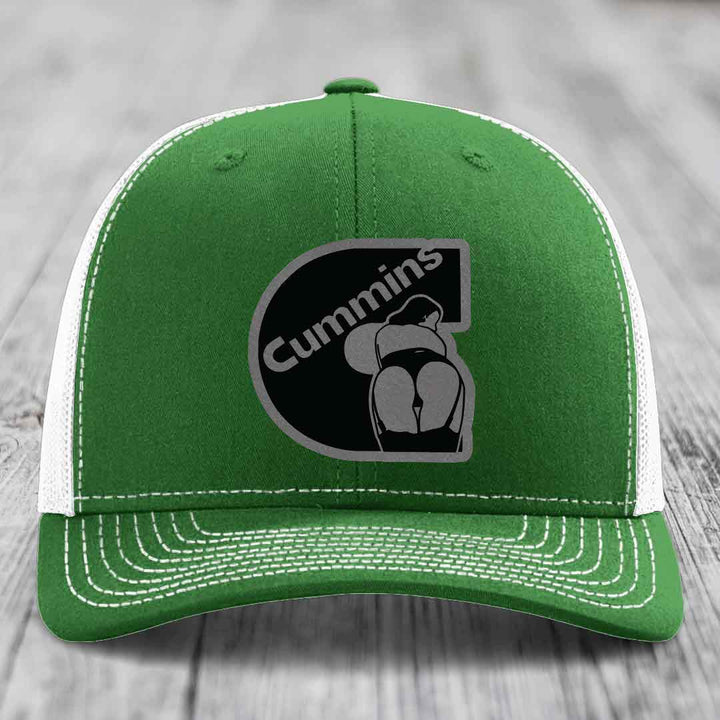 Beige trucker hat with black mesh back and Cummins logo patch on front.