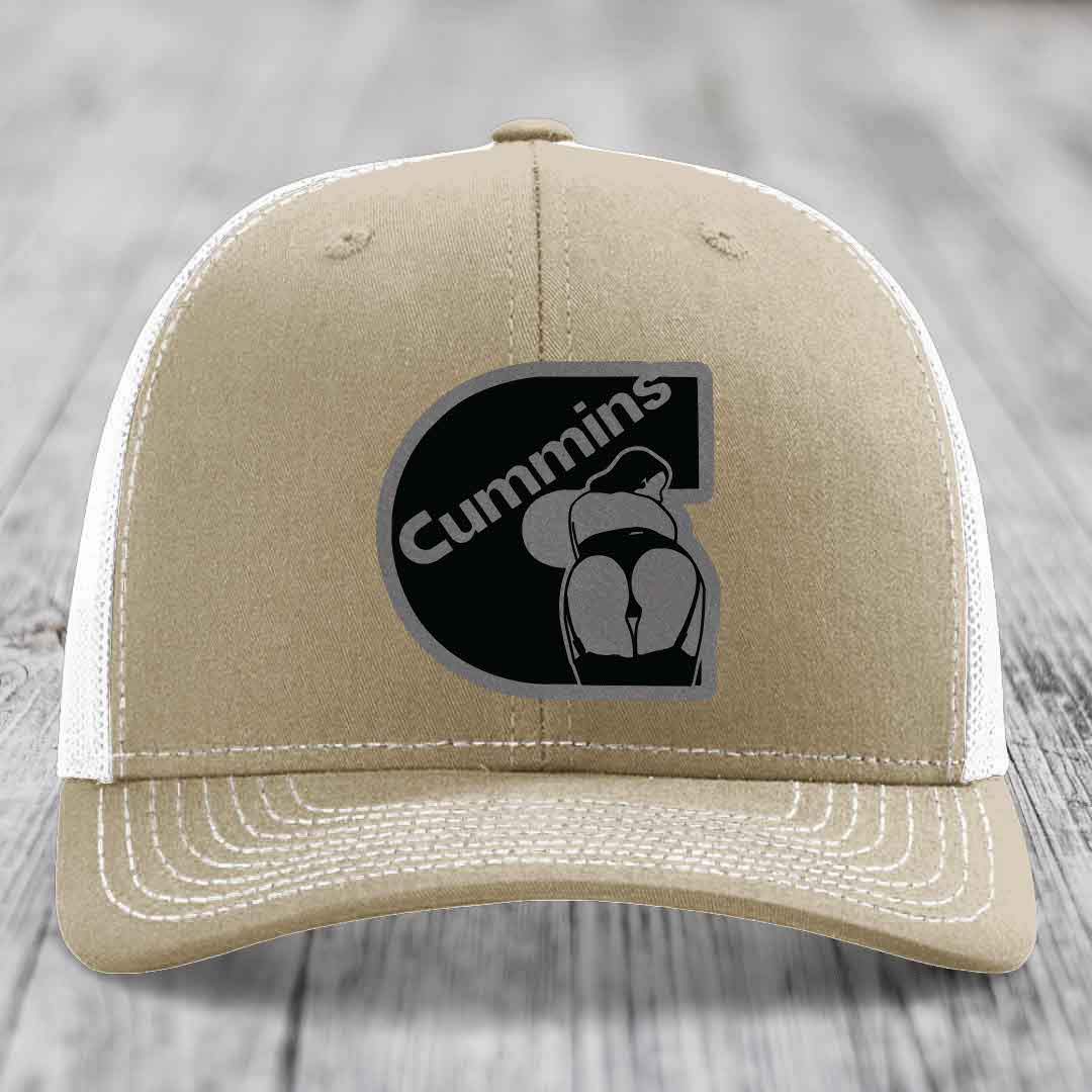 Olive green trucker hat with black Cummins logo patch featuring a stylized engine graphic.