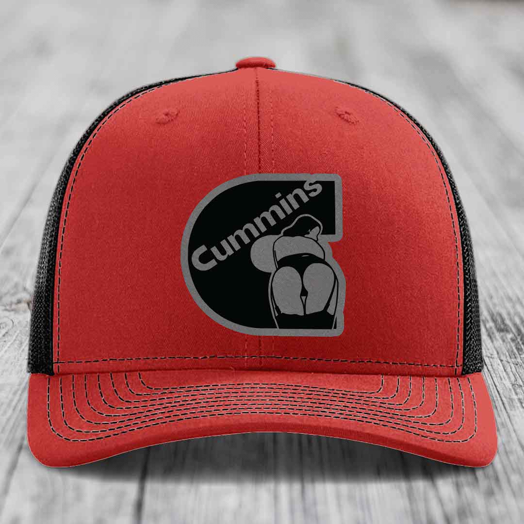 Blue trucker hat with black mesh back and Cummins logo patch on front.