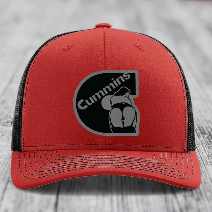 Blue trucker hat with black mesh back and Cummins logo patch on front.