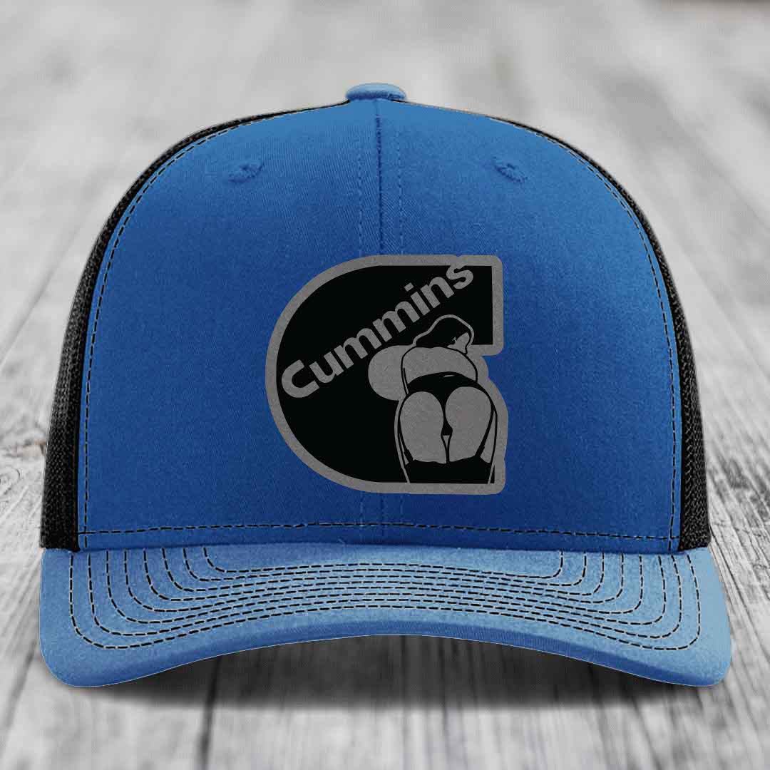 Blue and red trucker hat with Cummins logo patch on front, white stitching, and mesh back.