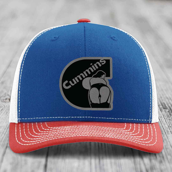 White trucker hat with black Cummins logo patch featuring a stylized engine design.