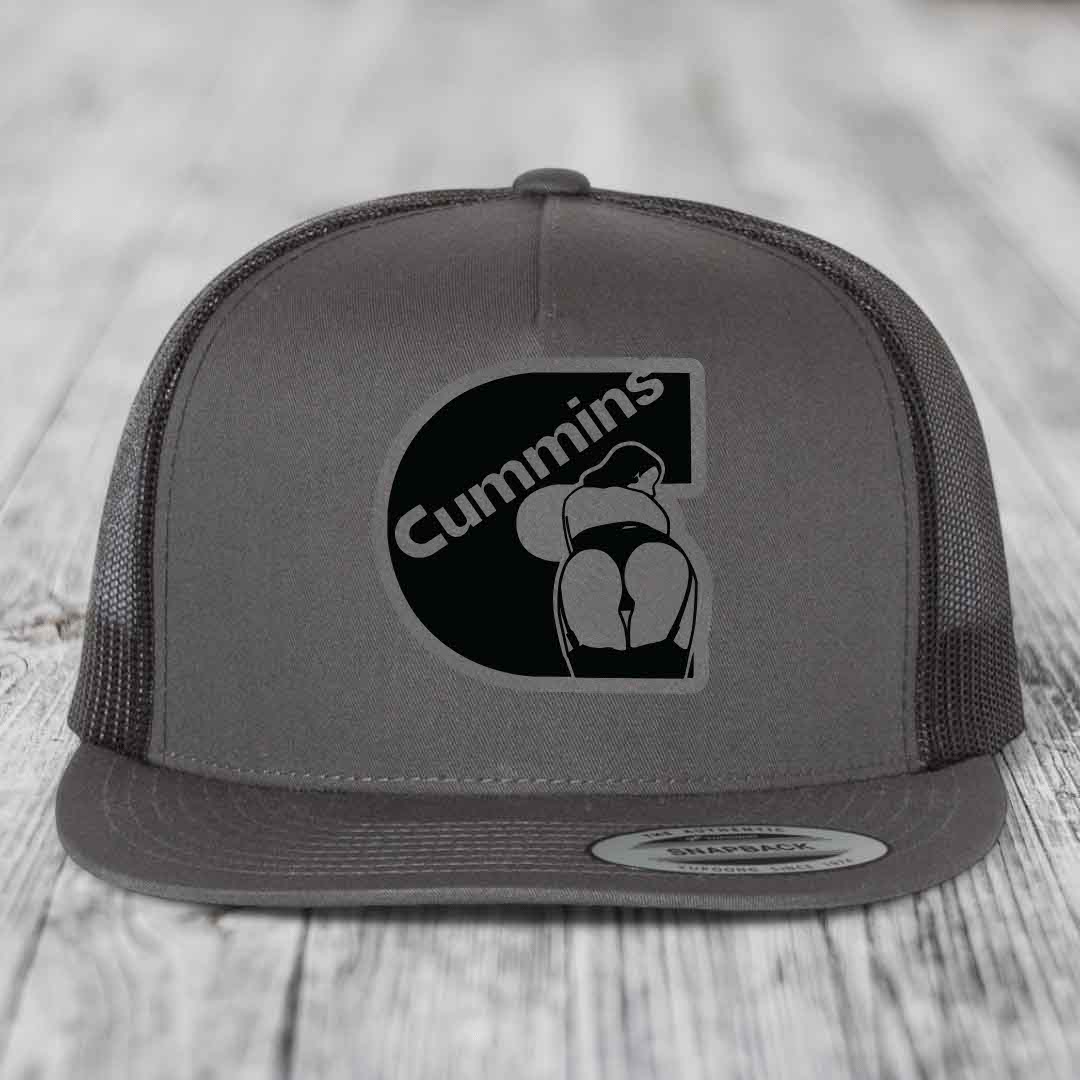 Grey trucker hat with black Cummins logo patch featuring a stylized &