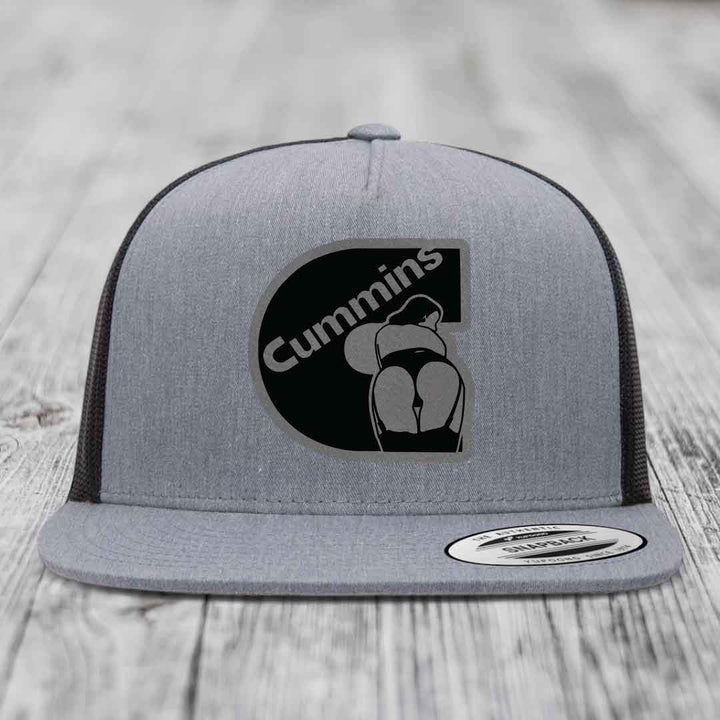Grey trucker hat with black Cummins logo patch featuring a stylized figure.