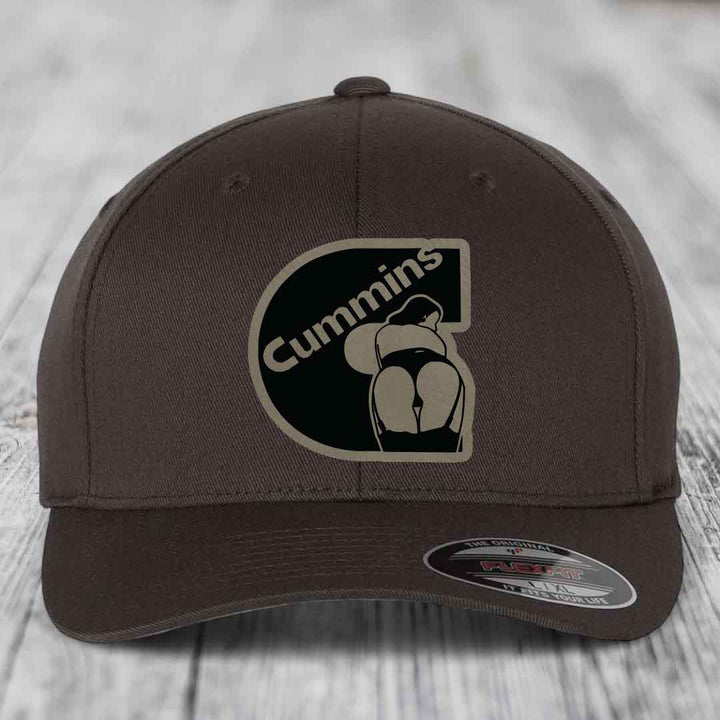 Beige baseball cap with black Cummins logo patch featuring a stylized engine design.
