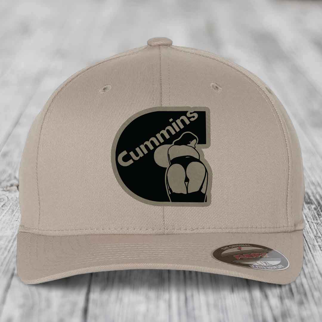 Beige baseball cap with black Cummins logo patch featuring a stylized engine design.