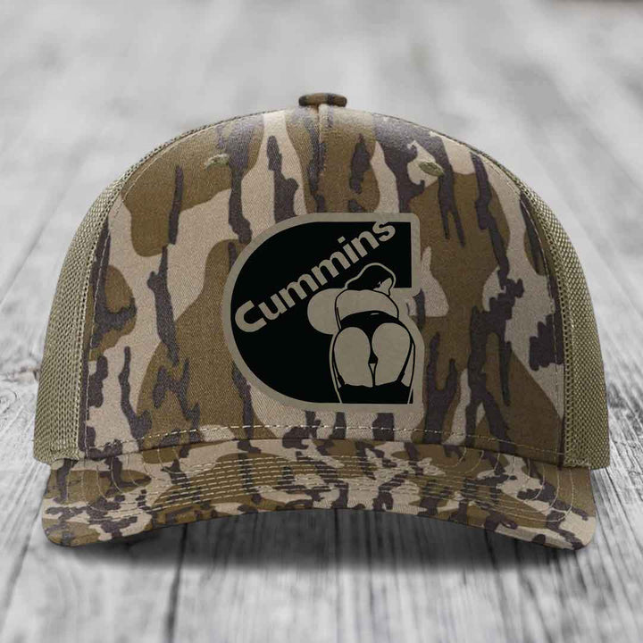 Blue and white trucker hat with a black Cummins logo patch on the front.