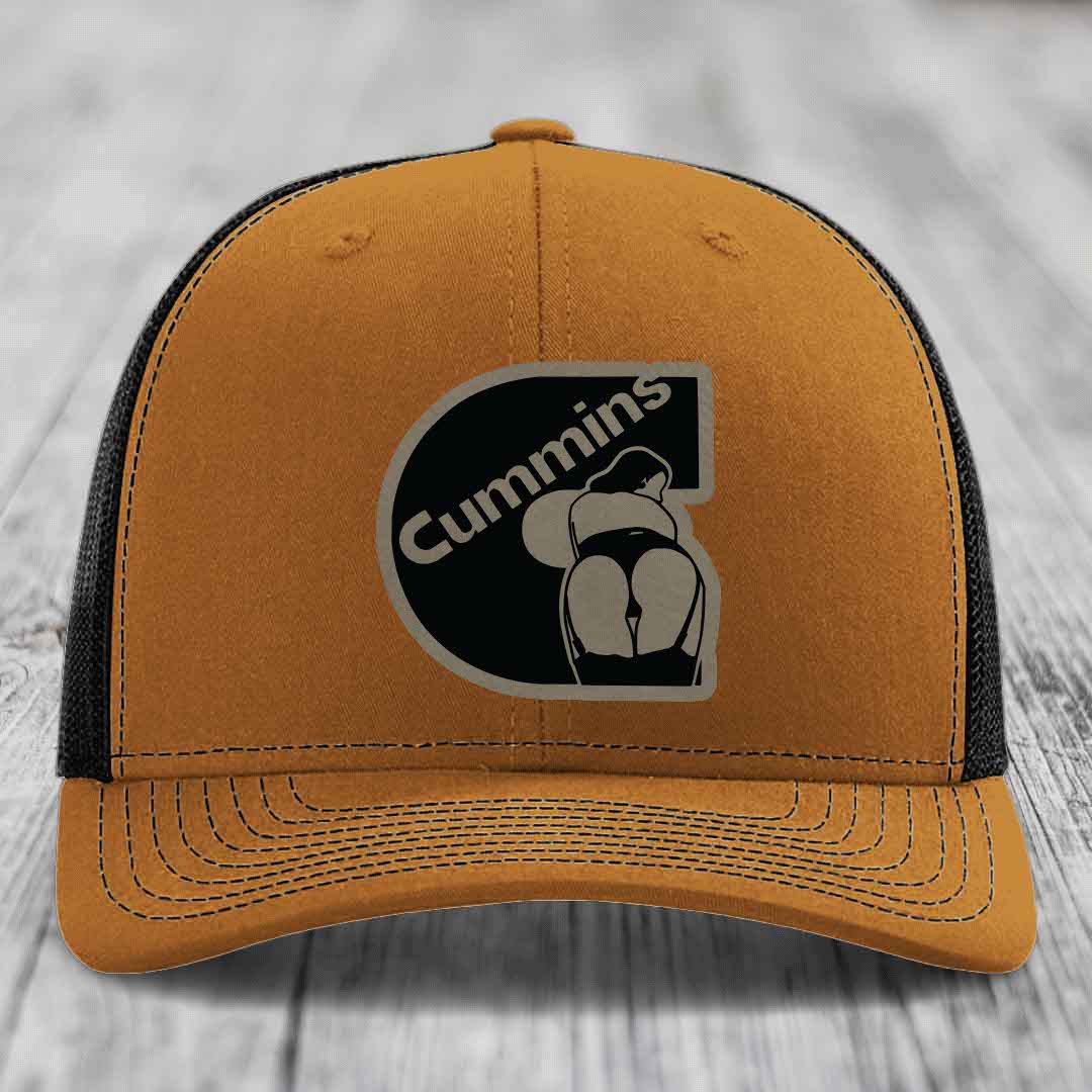 Grey trucker hat with black mesh back and Cummins logo patch on front.