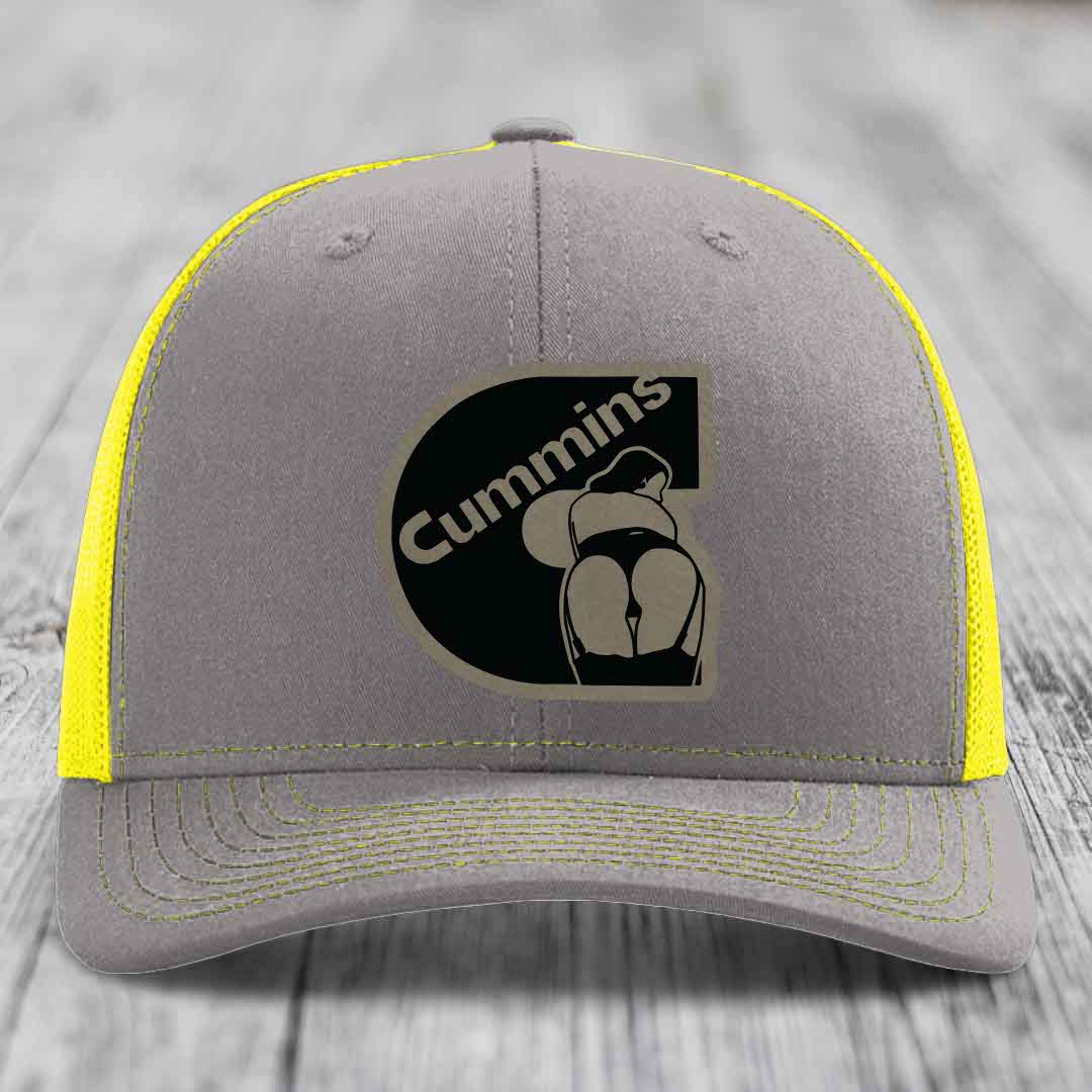 Brown trucker hat with black Cummins logo patch on front, cream mesh sides.
