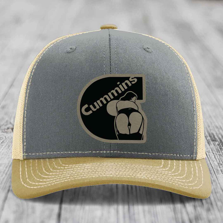 Grey trucker hat with black Cummins logo patch featuring a stylized engine design.