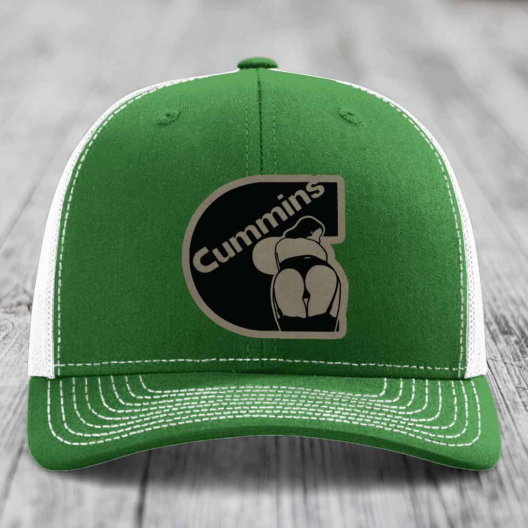 Beige trucker hat with black mesh back and Cummins logo patch on front.