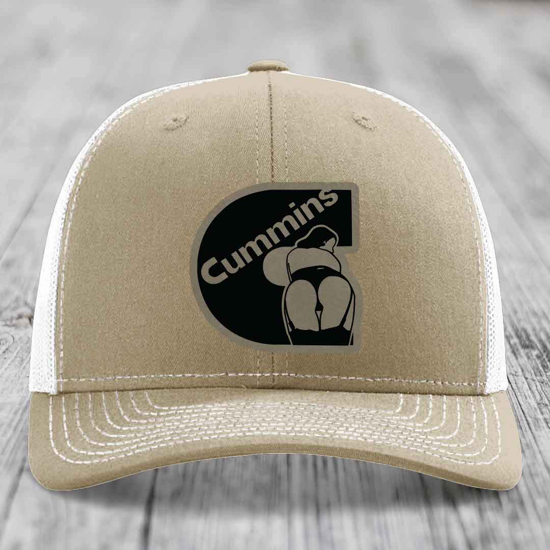 Olive green trucker hat with Cummins logo patch on front, featuring a stylized engine graphic.