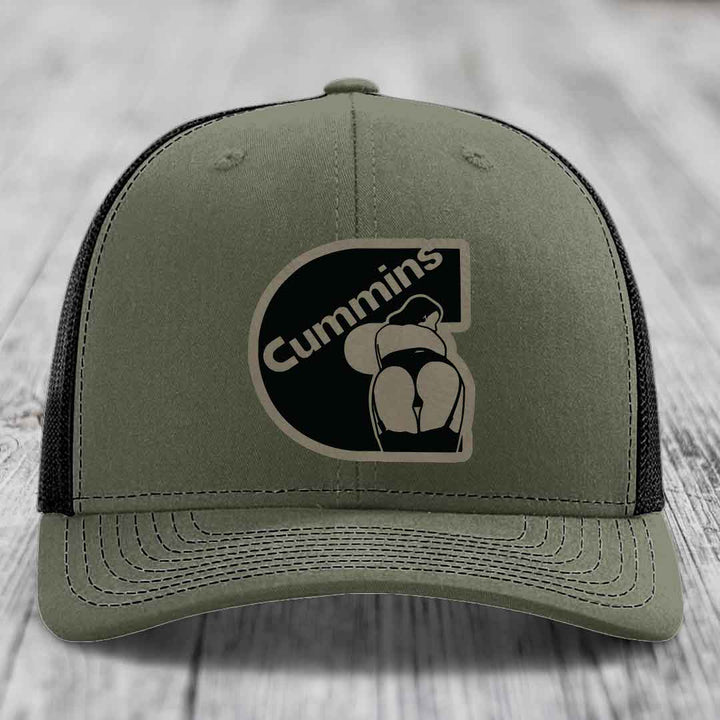 Black trucker hat with Cummins logo patch on front, featuring a stylized engine graphic.