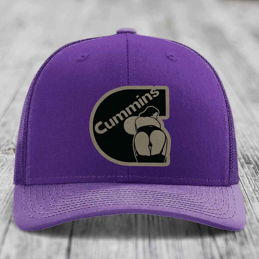 Red trucker hat with black mesh back and Cummins logo patch on front.