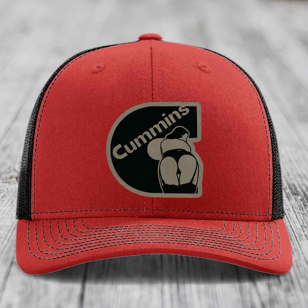 Blue trucker hat with black mesh back and Cummins logo patch on front.