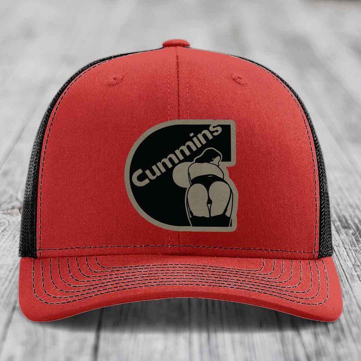 Blue trucker hat with black mesh back and Cummins logo patch on front.