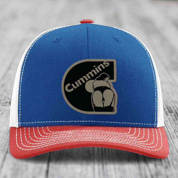 White trucker hat with black Cummins logo patch featuring a stylized engine design.