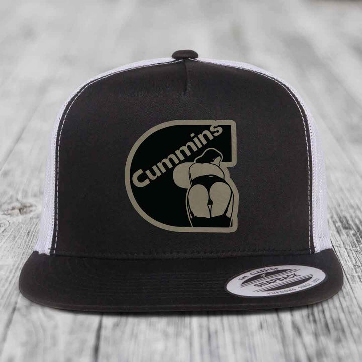 Grey trucker hat with black and beige Cummins logo patch on front.
