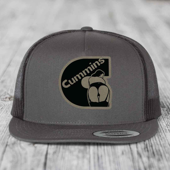 Grey trucker hat with black and tan Cummins logo patch on front.