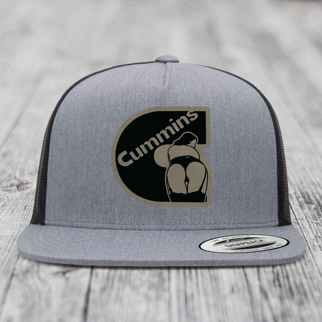 Grey trucker hat with black and tan Cummins logo patch on front, white mesh back.