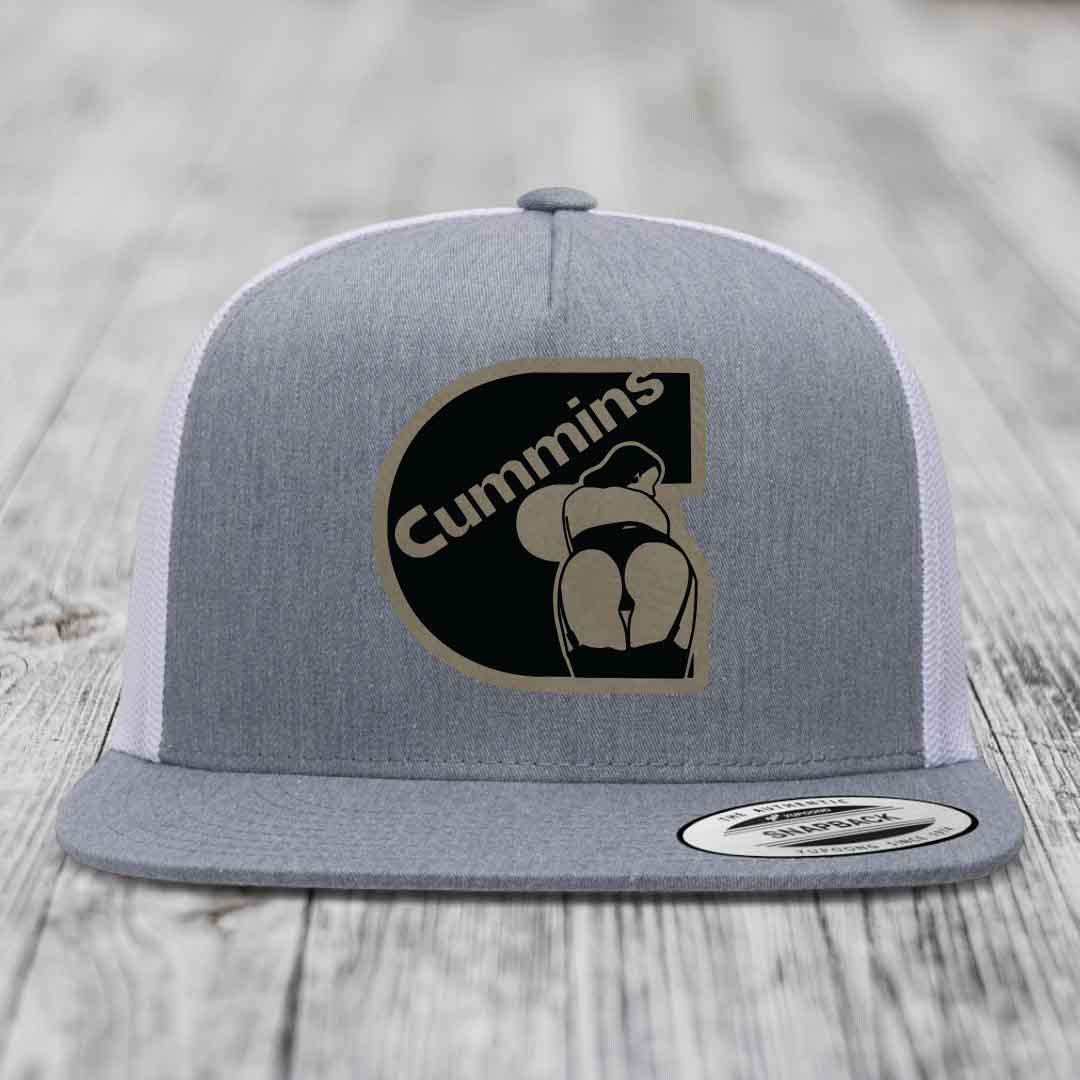 Grey front panel trucker hat with black and tan Cummins logo patch, white mesh back, and grey brim.