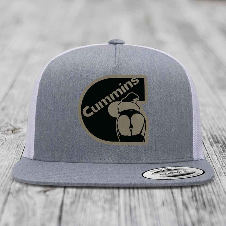 Grey front panel trucker hat with black and tan Cummins logo patch, white mesh back, and grey brim.