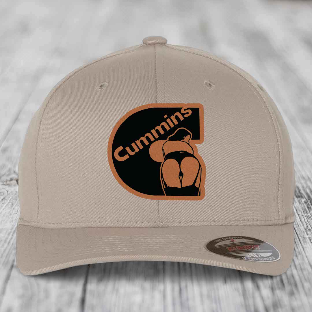 Beige baseball cap with black and tan Cummins logo patch featuring a stylized figure.