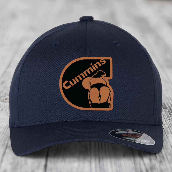 Red baseball cap with Cummins logo patch featuring a stylized &