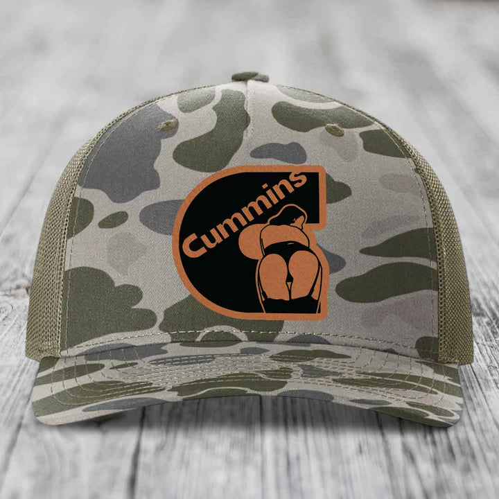 Camouflage trucker hat with brown leather patch featuring &