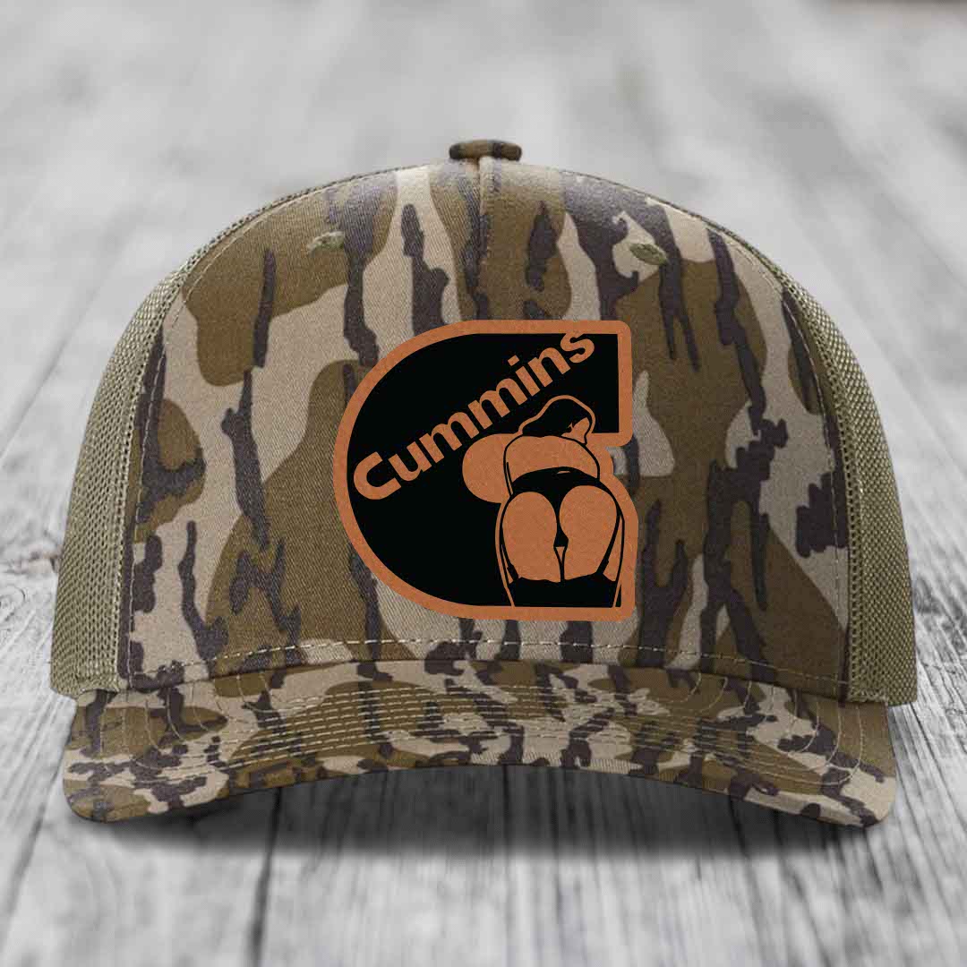 Blue and white trucker hat with a brown leatherette Cummins patch featuring a logo.