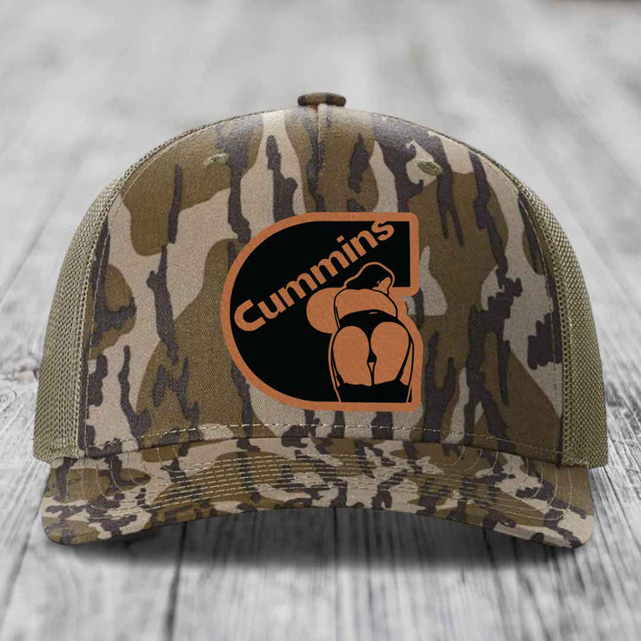 Blue and white trucker hat with a brown leatherette Cummins patch featuring a logo.