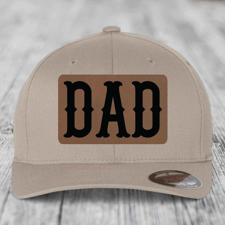 Dark blue baseball cap with a brown leatherette patch that reads &