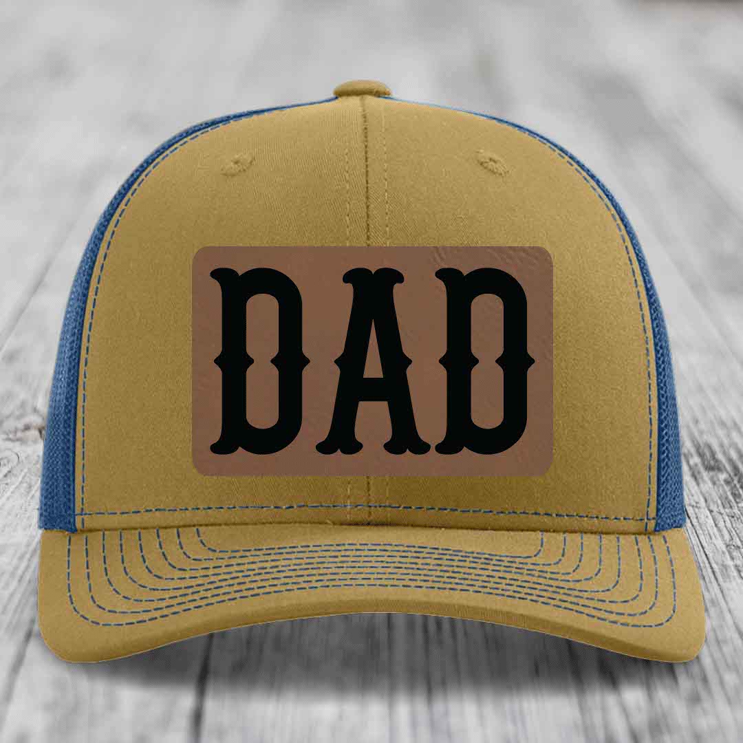 Black trucker hat with brown leather patch that says DAD in black letters.
