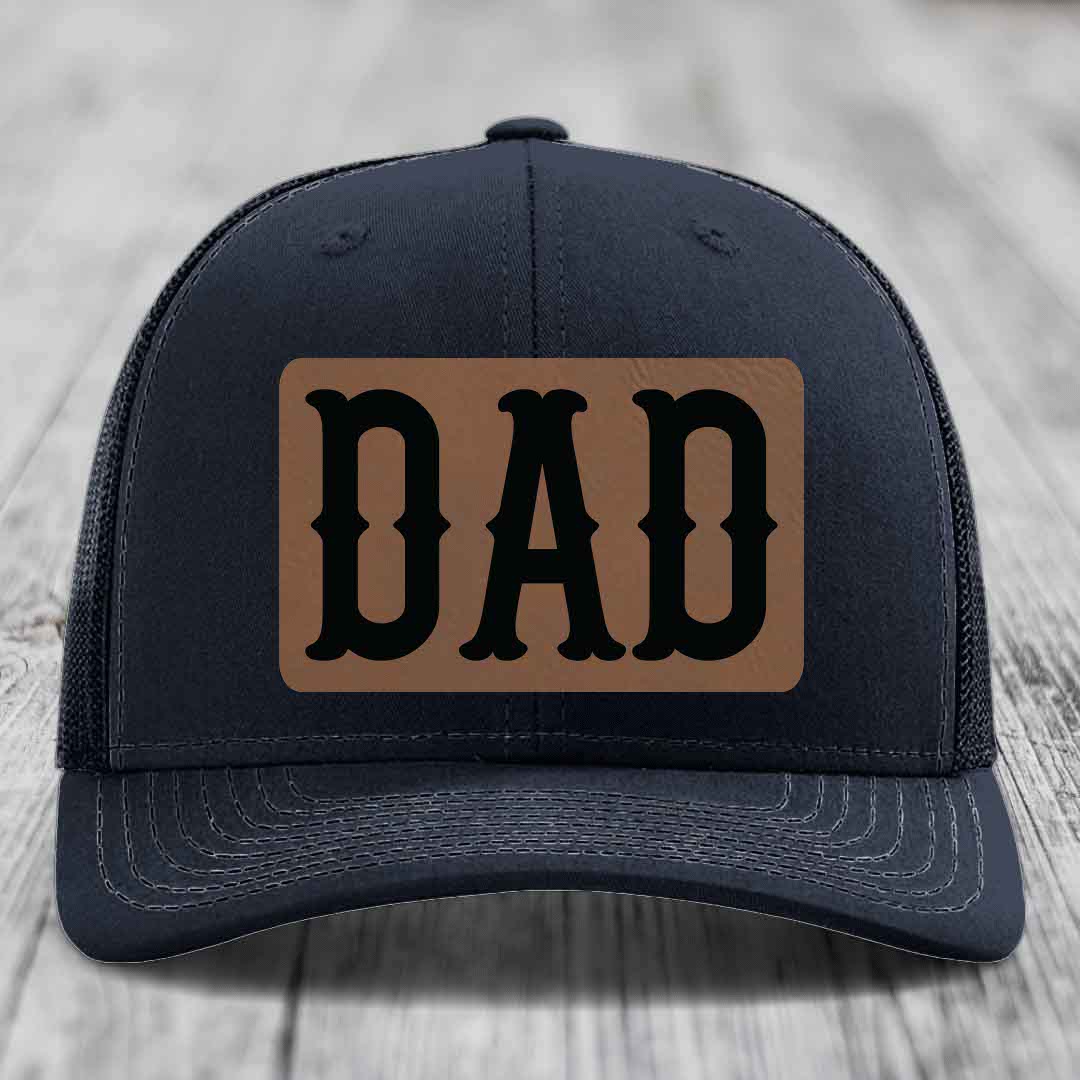 Purple trucker hat with brown leather patch that says DAD in black letters.