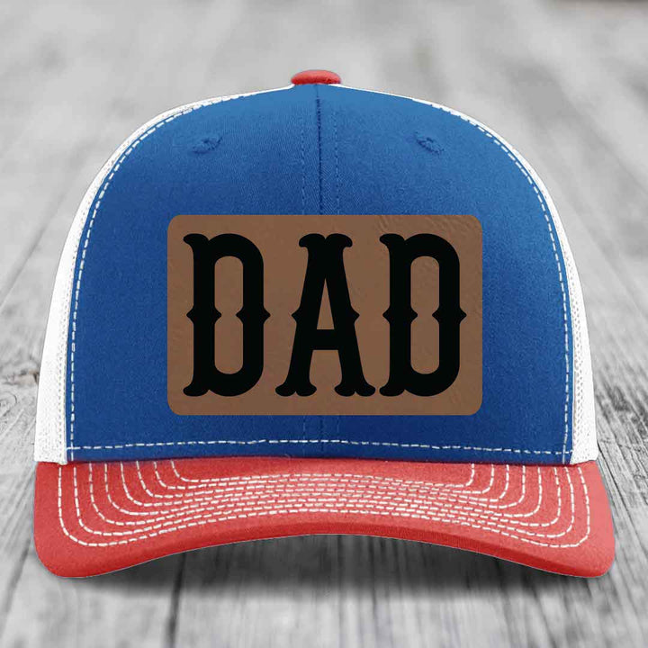 White trucker hat with brown leatherette patch featuring black &