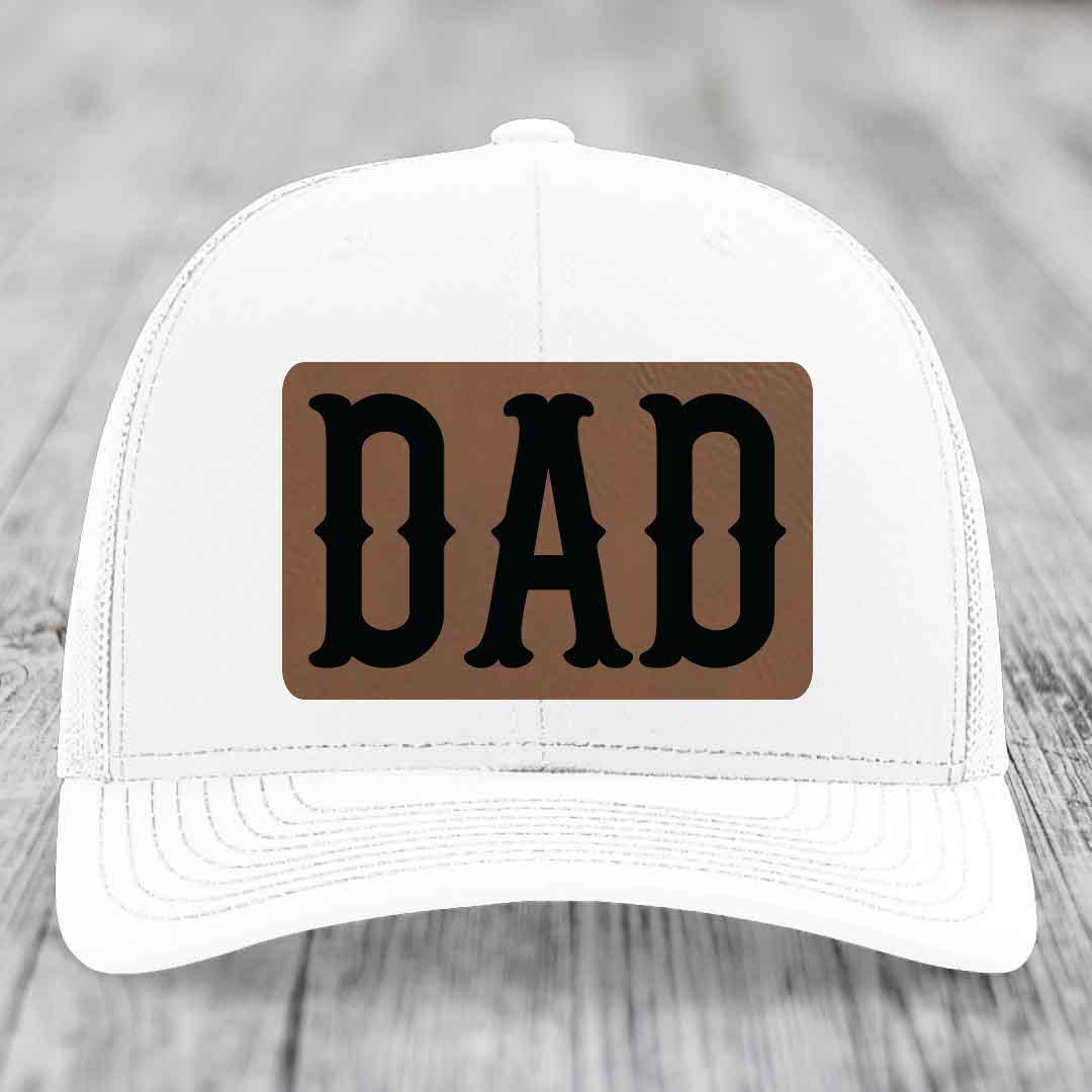 Camouflage trucker hat with brown leatherette patch that says DAD in black letters.
