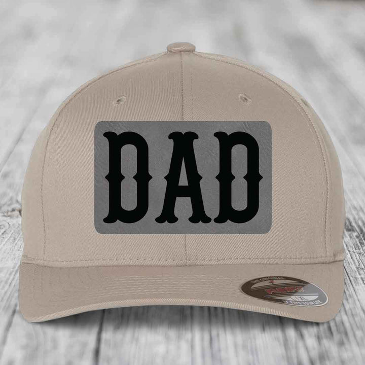Dark blue baseball cap with a grey rectangular patch featuring the word &