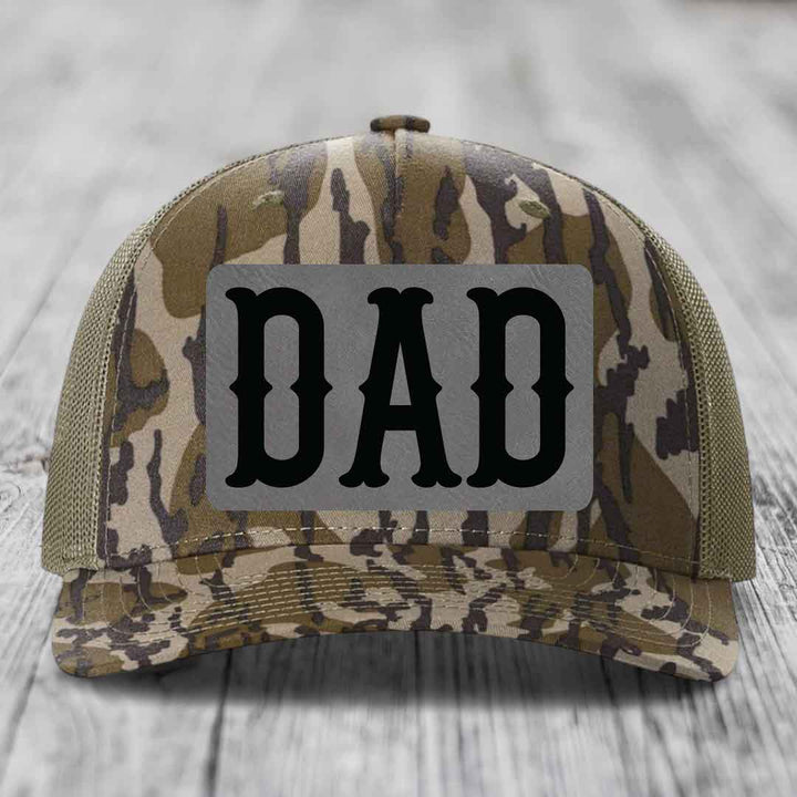 Blue and white trucker hat with a grey rectangular patch that says &
