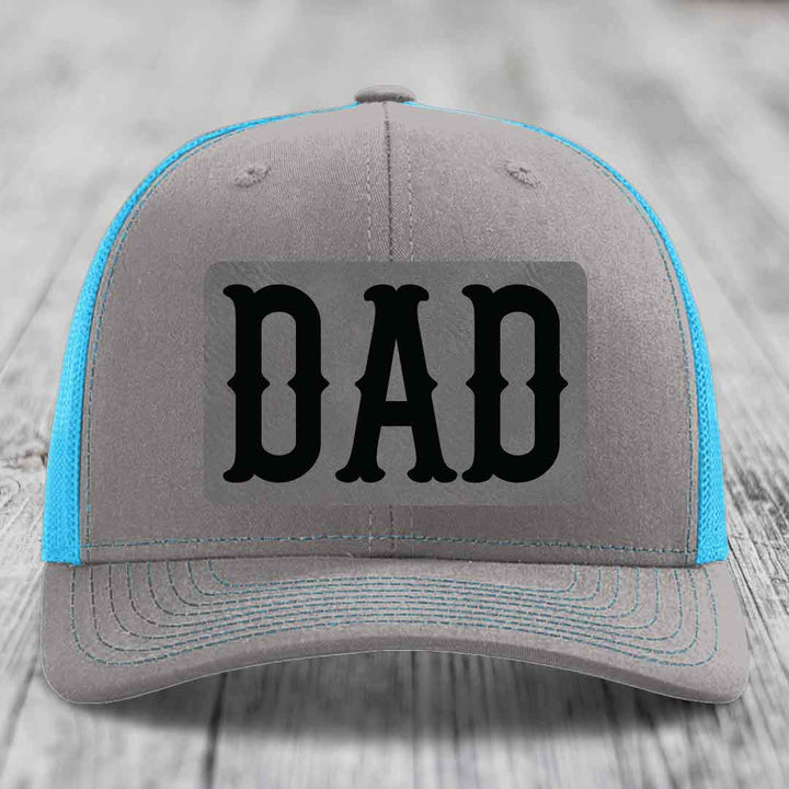 Grey trucker hat with neon green mesh and stitching, featuring a black &