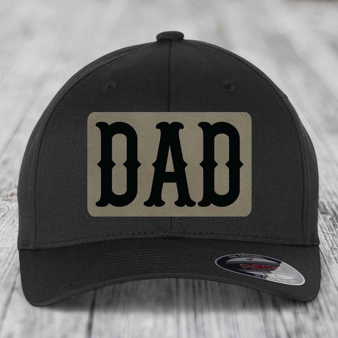 Black baseball cap with beige leatherette patch that says DAD in black letters.