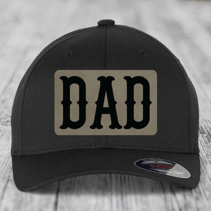 Black baseball cap with beige leatherette patch that says DAD in black letters.