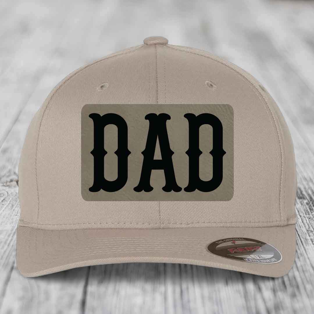 Dark blue baseball cap with a beige rectangular patch featuring black &