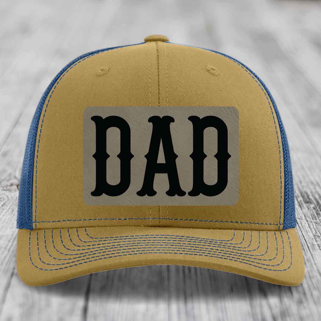 Black trucker hat with beige rectangular patch featuring black &