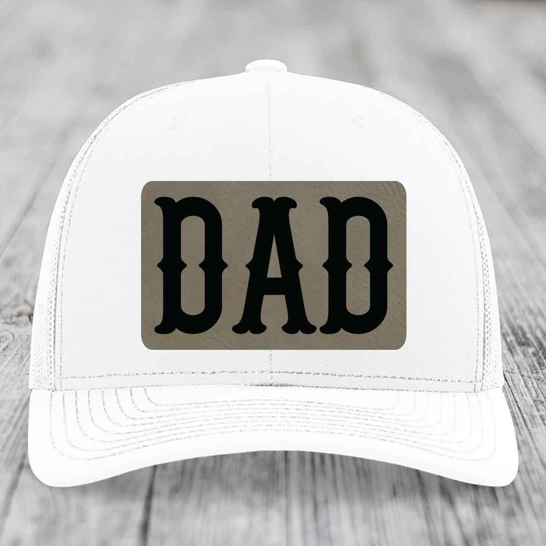 Black trucker hat with brown leather patch that says DAD in black letters.