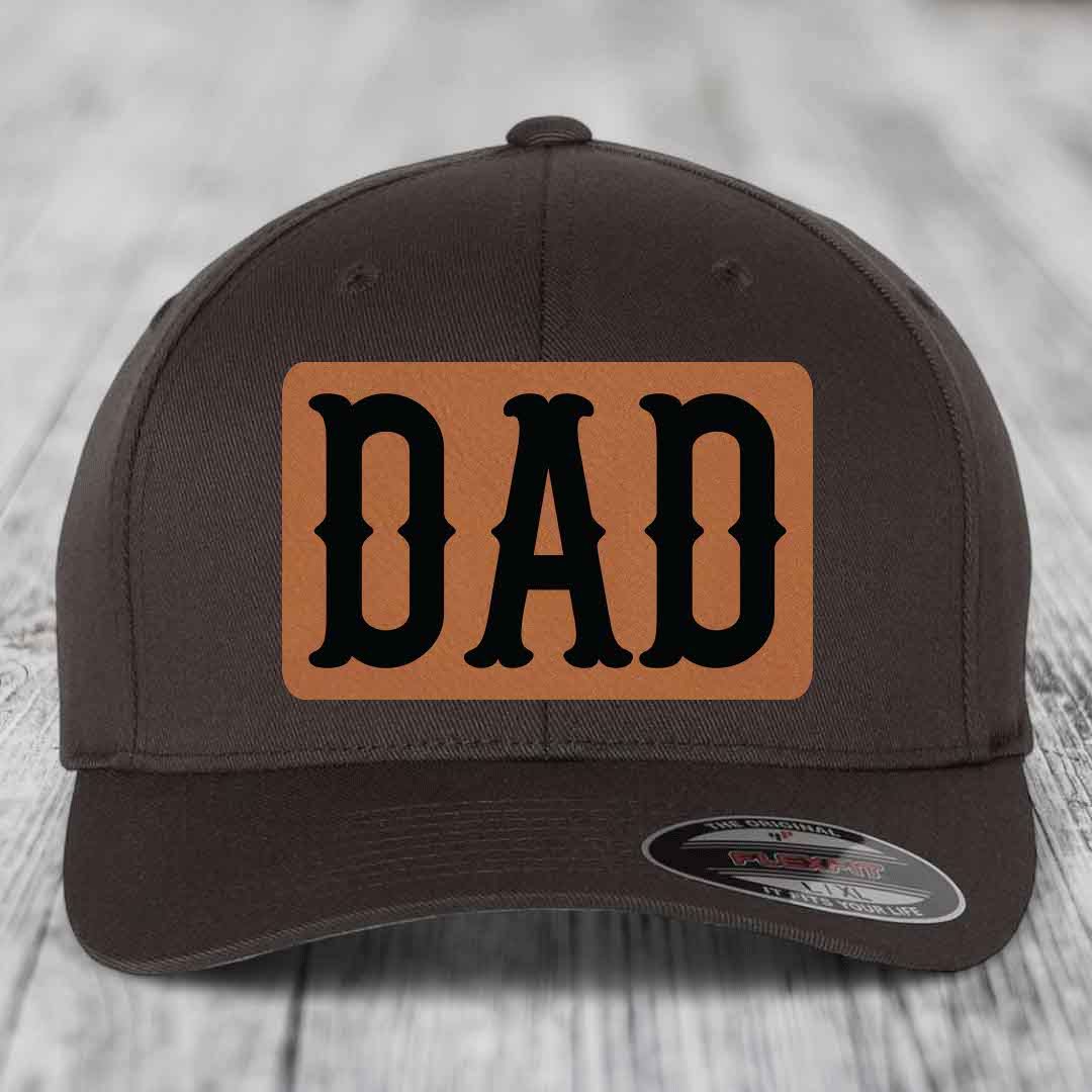Dark brown baseball cap with a tan leatherette patch that says DAD in black letters.